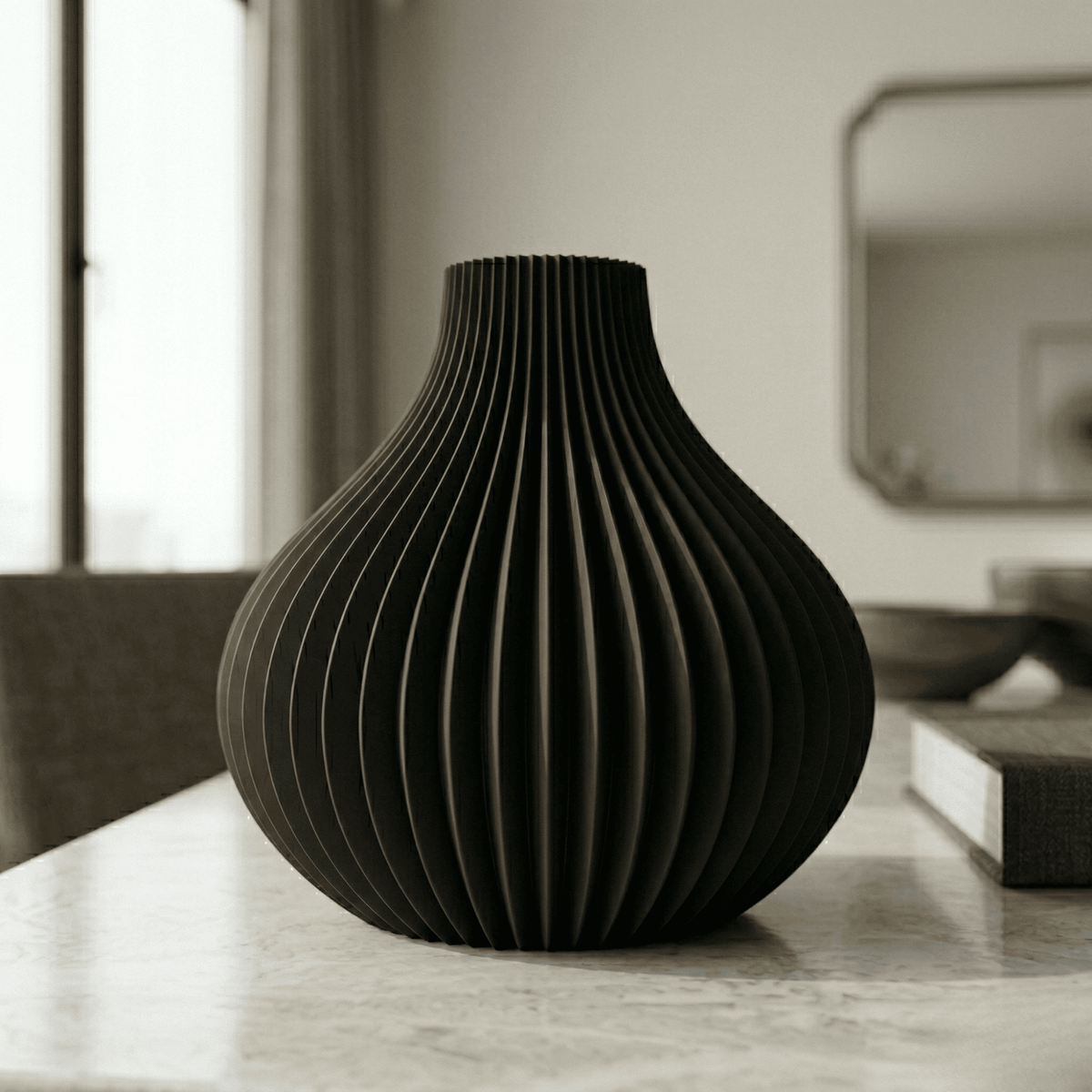 Black textured vase on a marble surface with a blurred background