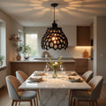Dining room with marble table, chairs, and a modern pendant light.