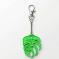 Green leaf-shaped keychain with a metal clasp on a white background