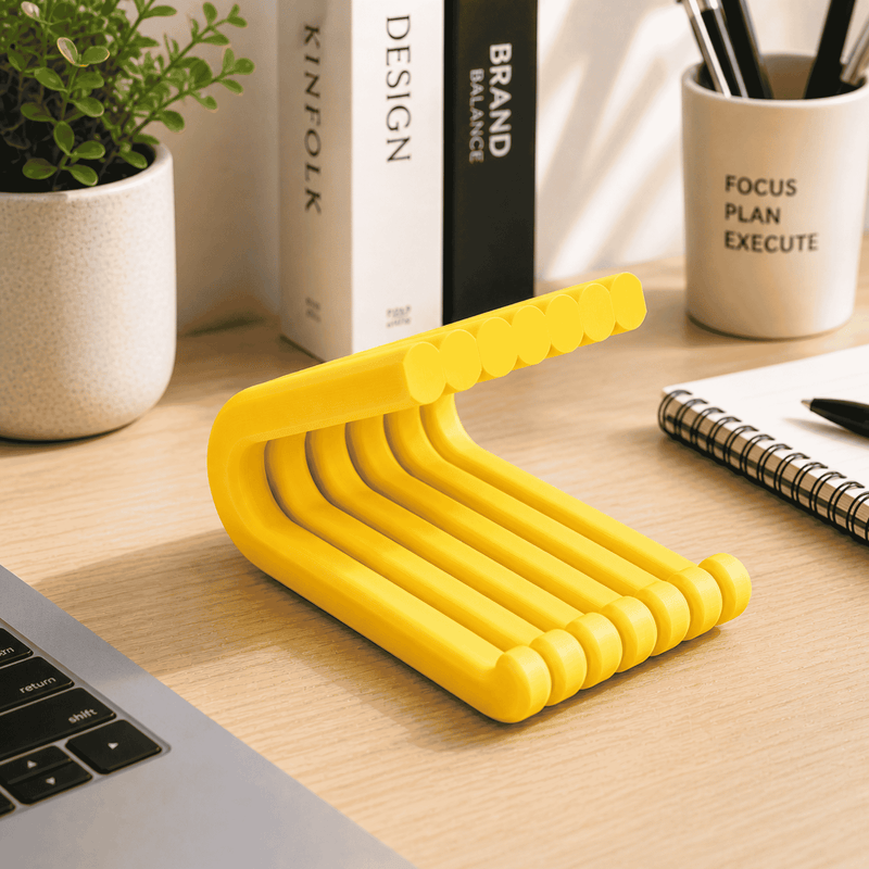 Yellow desk organizer on a wooden desk with books and stationery items.