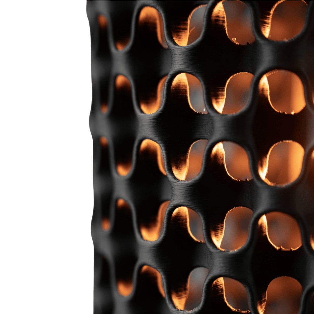 Close-up of a black metal mesh with a textured pattern on a white background