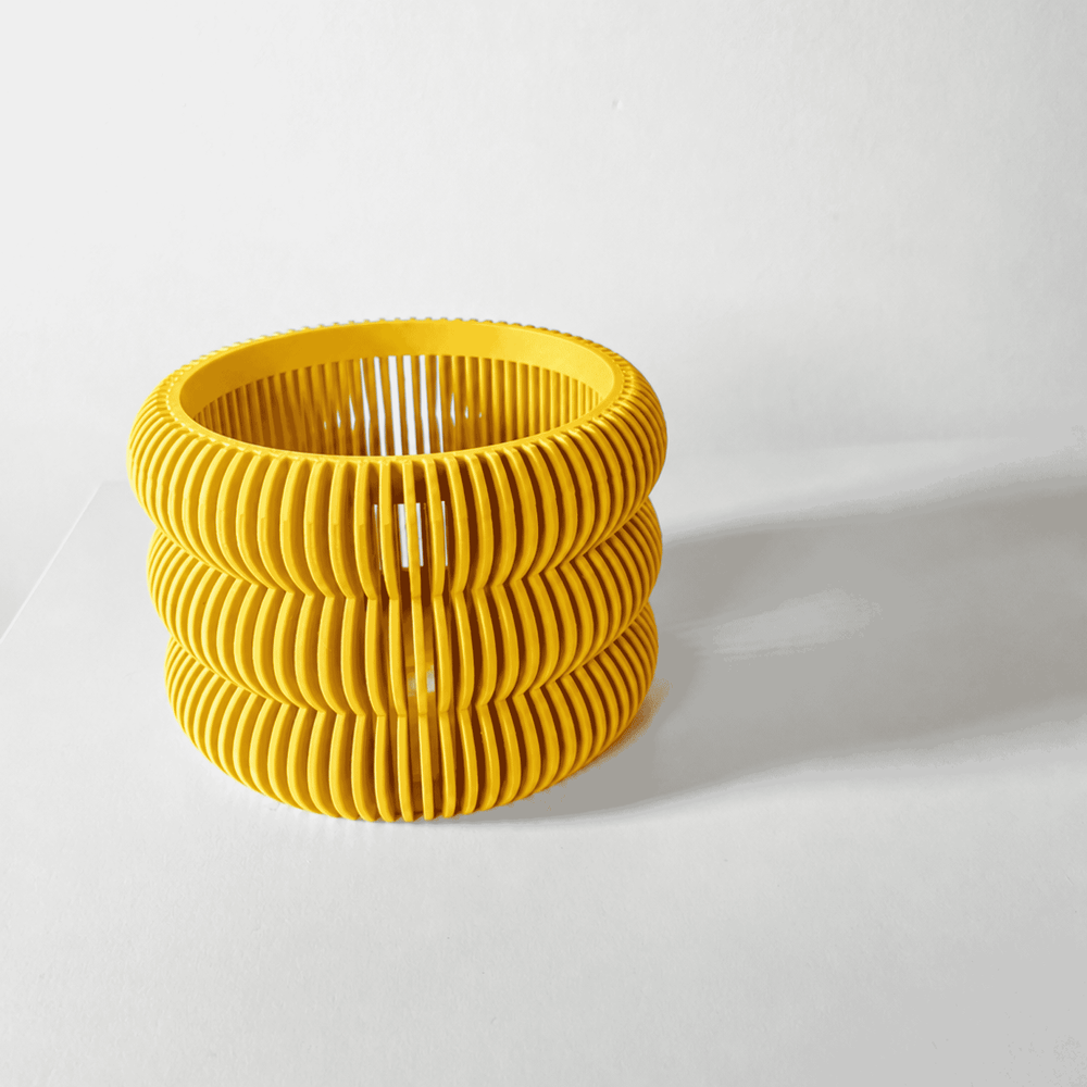 Yellow ribbed planter on a white background