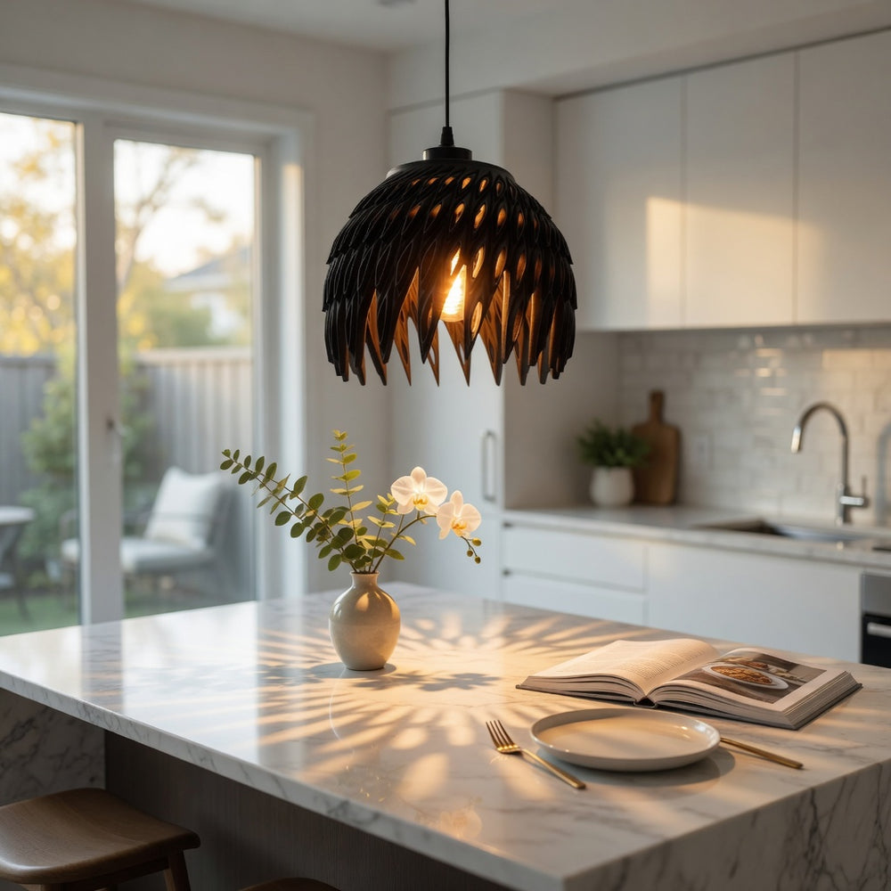 Modern kitchen with a pendant light, marble island, and decorative elements.
