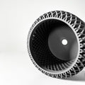 Close-up of a black and silver tire with unique tread pattern on a white background