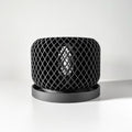Black lattice-patterned planter on a white background