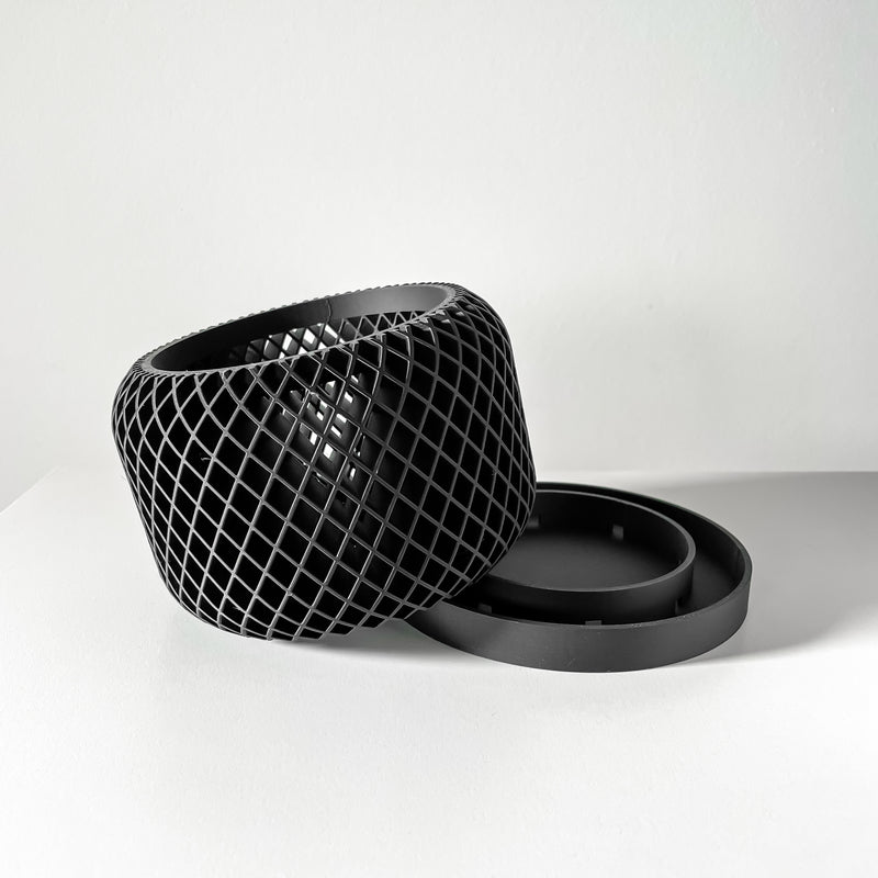 Black woven basket with a lid on a white background